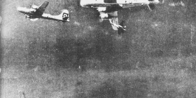 Fighter aircraft making a pass under a B-29 (July 7, 1944)