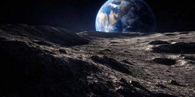 Lunar surface stretching from deep shadow into sunlight with Earth rising above the horizon in the blackness of space.