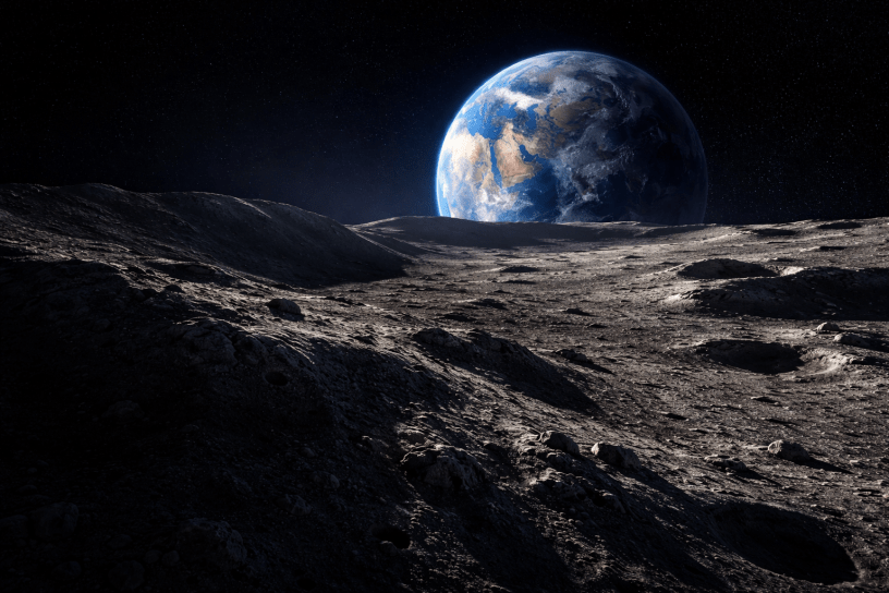 Lunar surface stretching from deep shadow into sunlight with Earth rising above the horizon in the blackness of space.