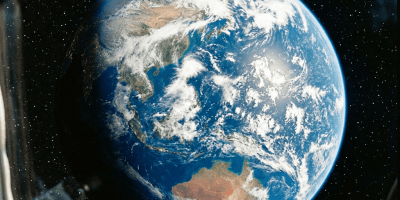 Earth with visible continents and clouds, viewed through spacecraft window frame in space