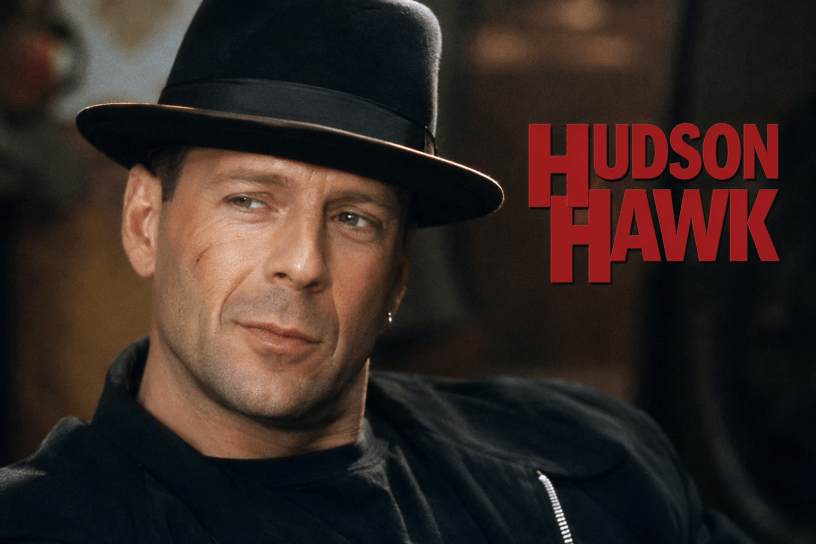 AI-generated cinematic portrait of Bruce Willis as Hudson Hawk, wearing a black fedora and dark clothing beside the red words “Hudson Hawk.”