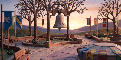 Bell hanging in a plaza surrounded by international flags at sunset