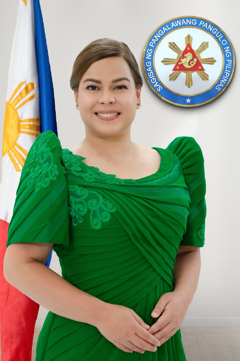 Official portrait of Philippine Vice President Sara Duterte smiling in a green formal dress, with the Philippine flag and vice-presidential seal displayed behind her.